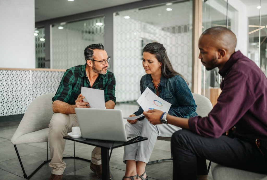 Casual meeting of diverse business team analyzing financial data